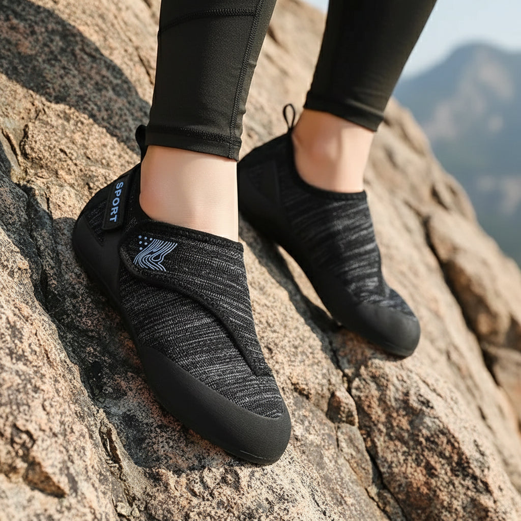 Black athletic shoe with a brand logo on a blue surface

