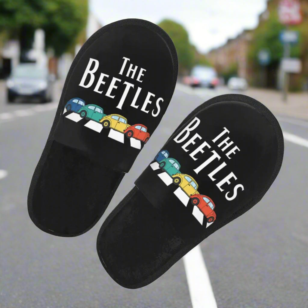 Black slippers with 'The Beetles' design on a white background