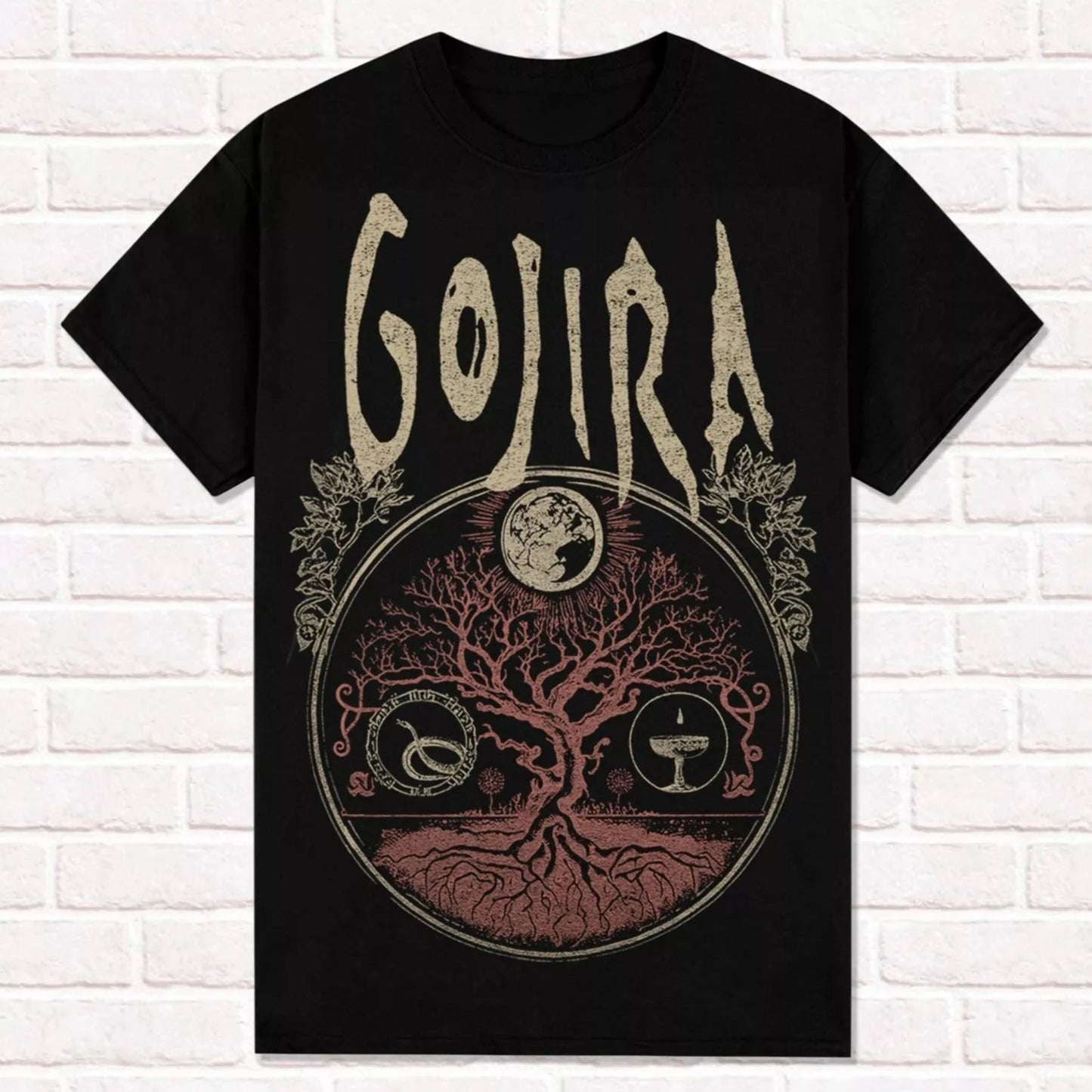 Black t-shirt with 'Gojira' logo and tree design on a white brick wall background