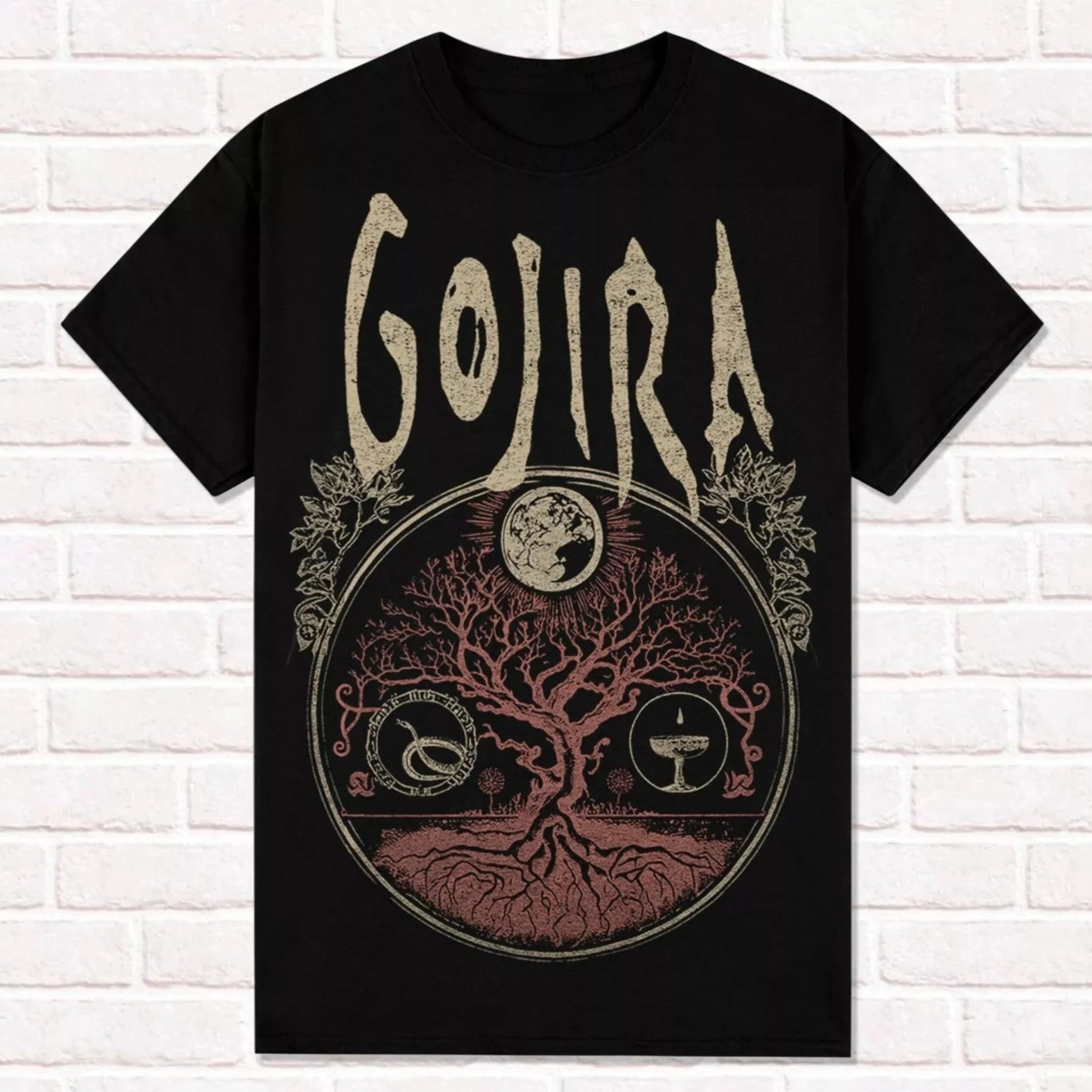 Black t-shirt with 'Gojira' logo and tree design on a white brick wall background