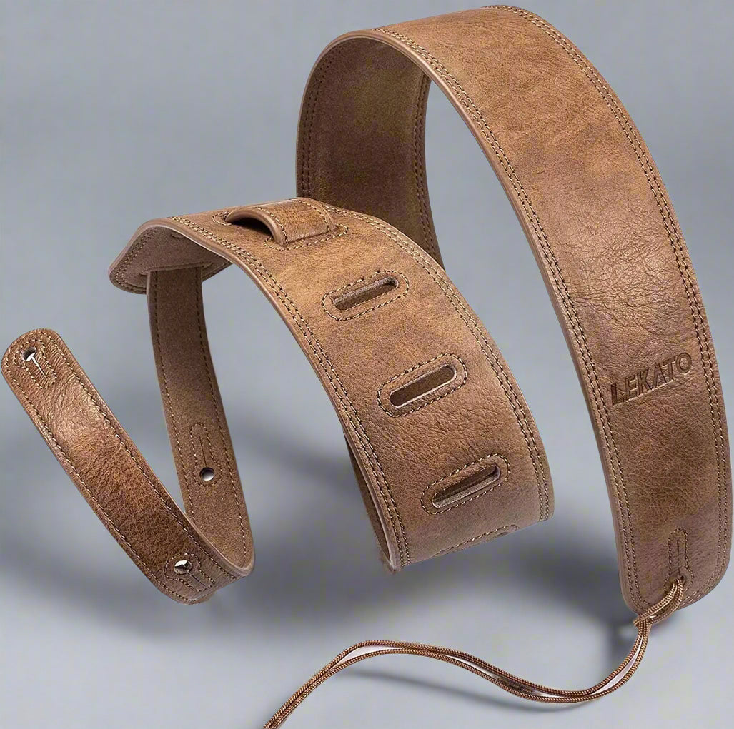 Brown leather guitar strap with brand name on a white background