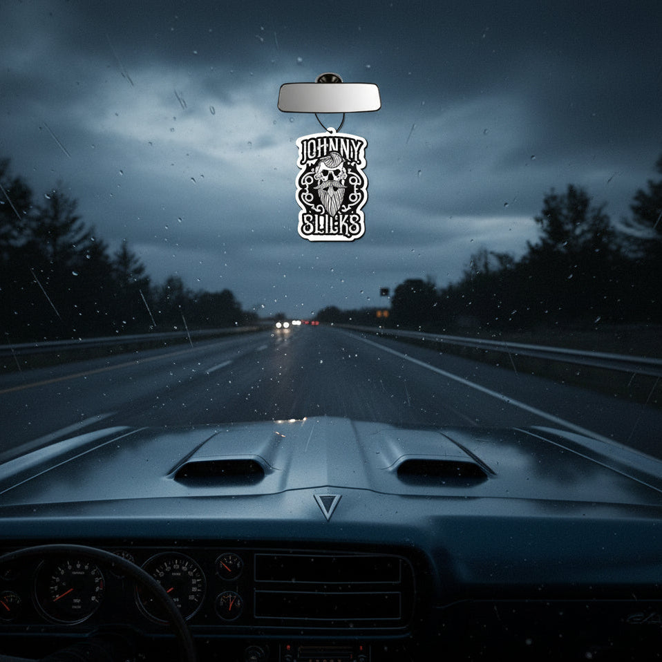 Car air freshener with skull design and 'Johnny Slicks' text on a white background