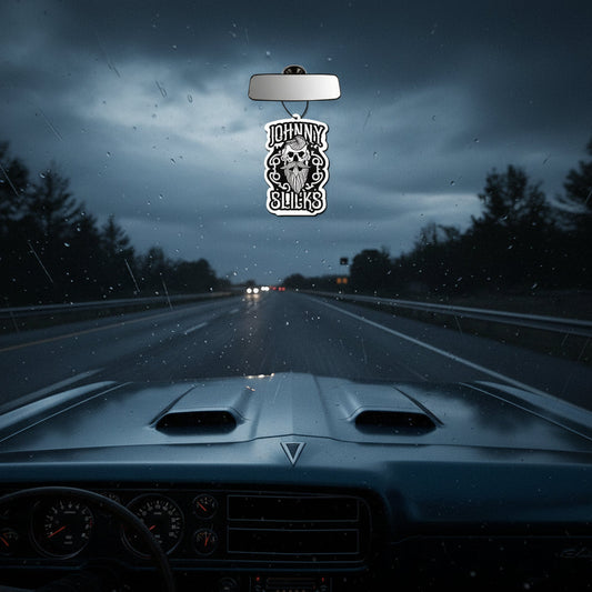 Car air freshener with skull design and 'Johnny Slicks' text on a white background