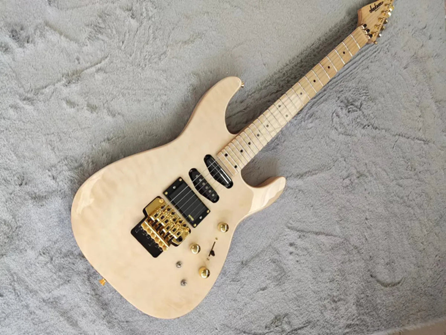 Electric guitar with a blonde finish on a gray textured background
