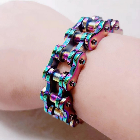 Multicolored chain bracelet on a wrist against a neutral background