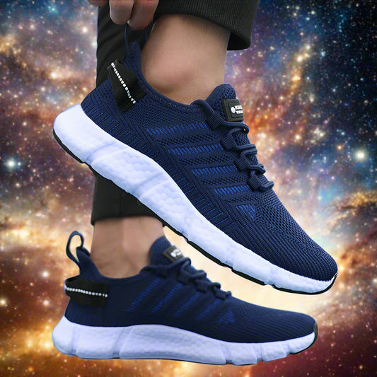 Navy running shoes with white soles worn by a person on a blurred outdoor background