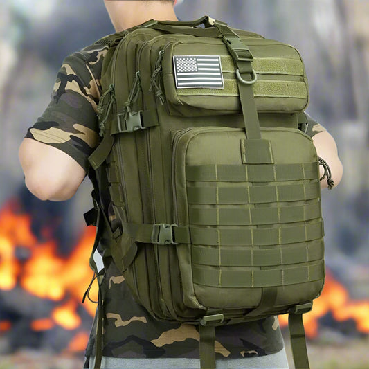 Person wearing a green tactical backpack with an American flag patch on a white background