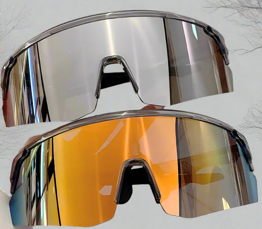 Sunglasses with reflective silver frame and orange lens held by a hand against a light background