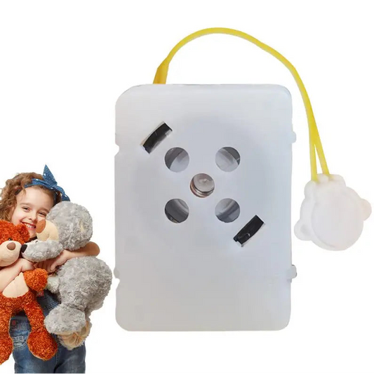 White electronic device with buttons and a yellow cable on a white background, next to a child holding teddy bears.
