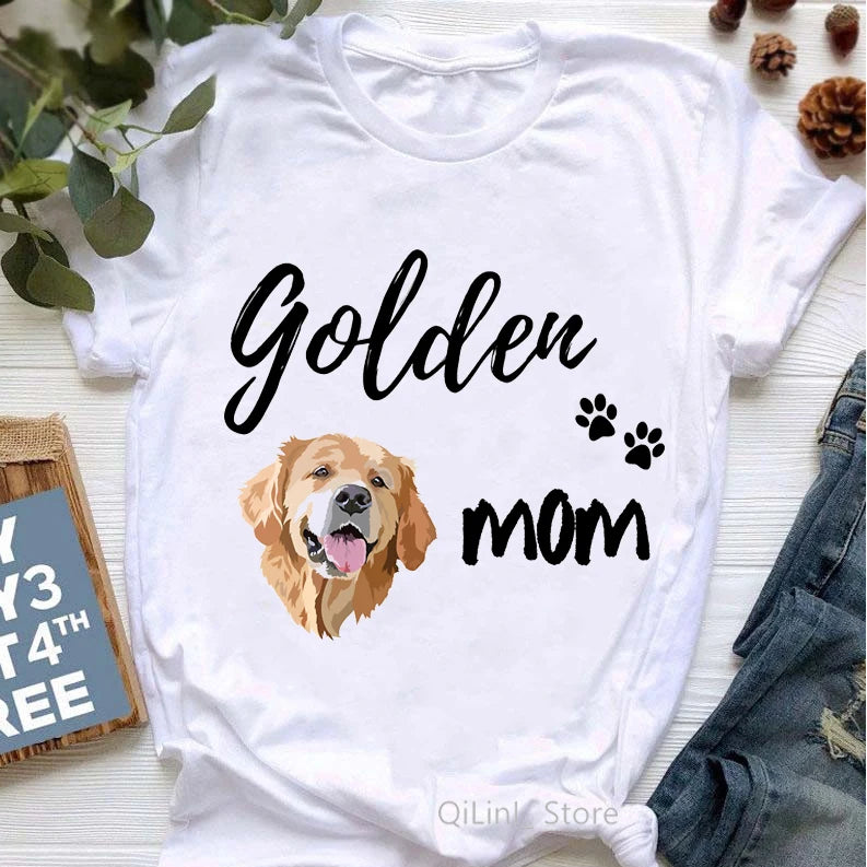 White t-shirt with a Golden Retriever graphic and 'Golden Mom' text on a light wooden surface.