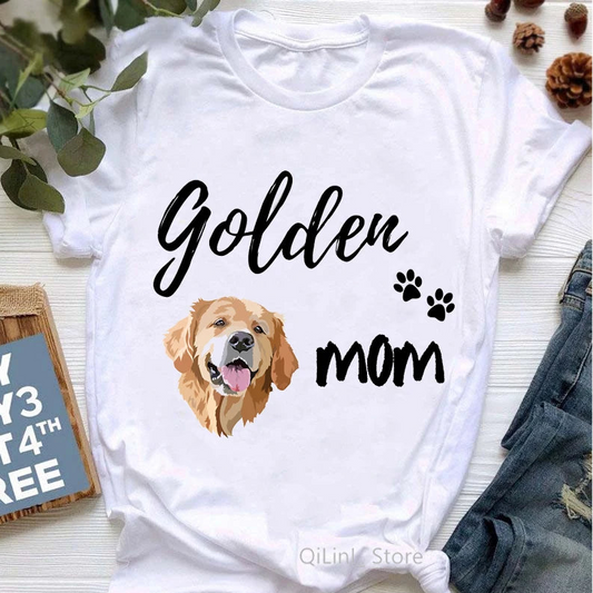 White t-shirt with a Golden Retriever graphic and 'Golden Mom' text on a light wooden surface.