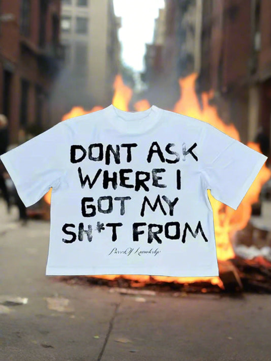 White t-shirt with black text on a concrete surface