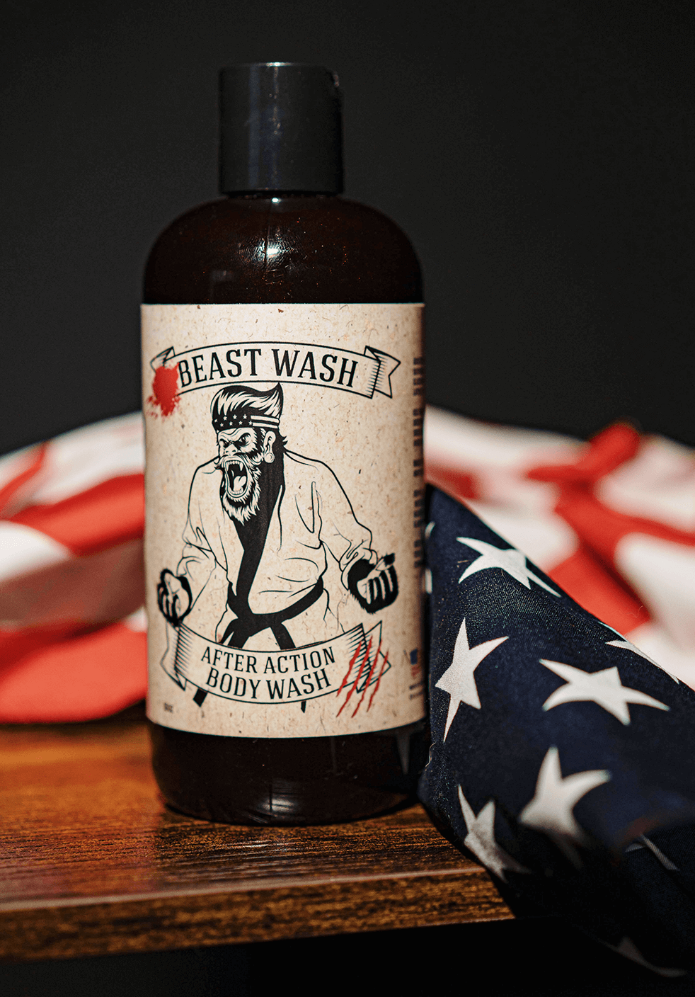 Bottle of 'Beast Wash' after action body wash with a label featuring a graphic design on an American flag background.