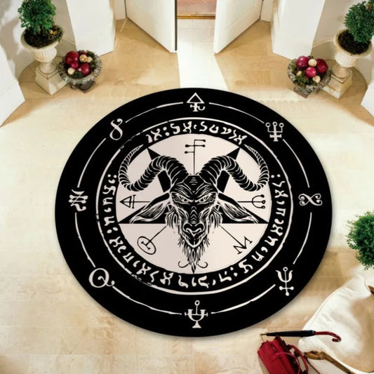 Round black rug with a central design featuring a goat head and symbols on a beige carpet.